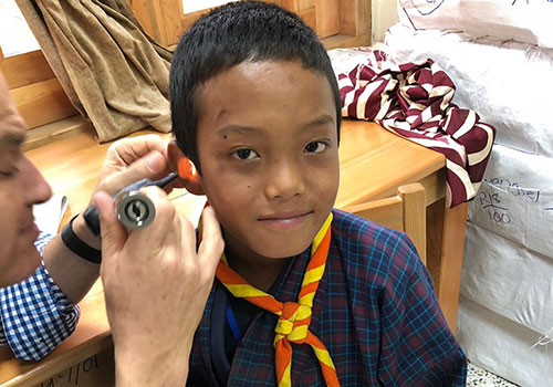 Prof. Friedland treating ear conditions at a remote clinic in Bhutan